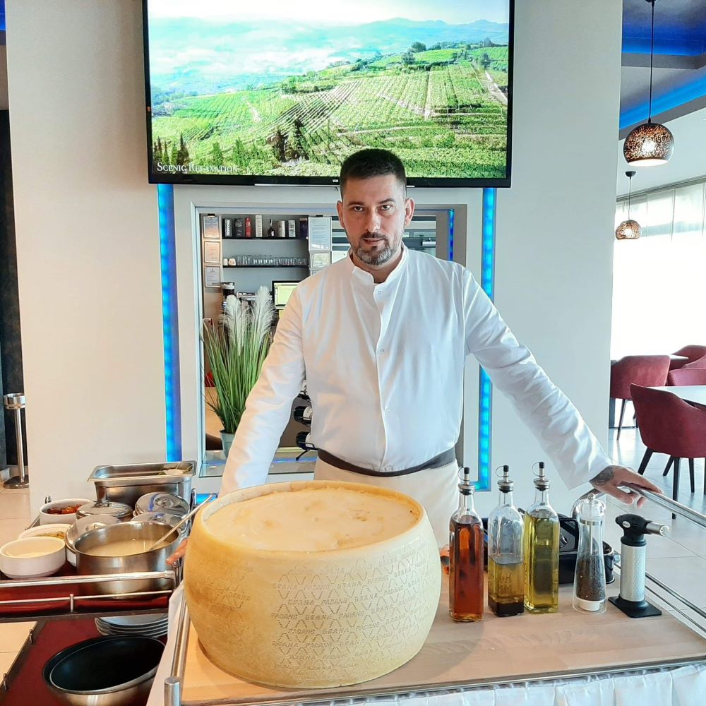 Đorđo Ćetković tokom rada, za kolicima sa točkom sira grana padano u sali restorana, maj 2021. Foto: lična arhiva Đorđa Ćetkovića